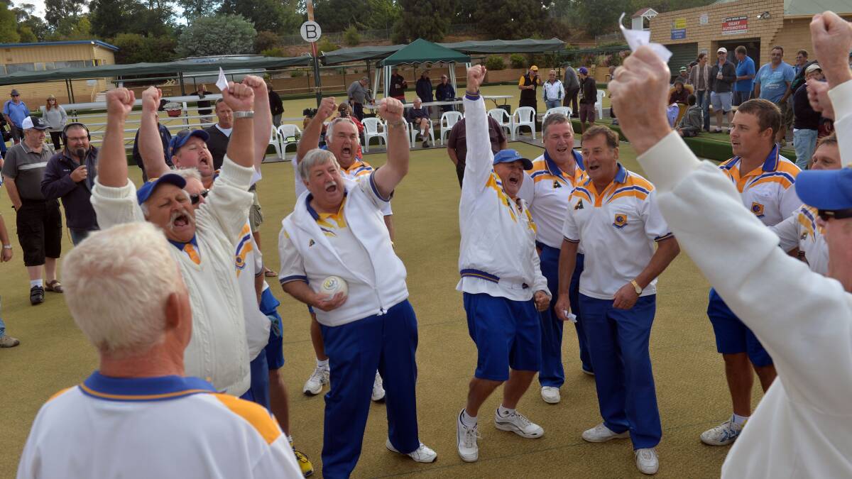Golden Square players celebrate their drought-breaking flag.