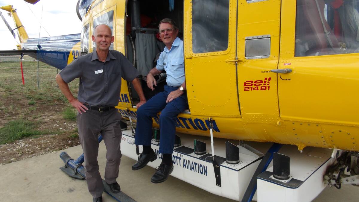 DEPI Program Manager Preparedness and Response Carsten Nannestad and CFA Aircraft Officer Ian Johnson with the Bell 214 B1 fire bomber. Picture: Leigh Sharp