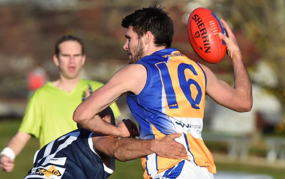 HEAT ON: Bendigo’s Jon Coe is tackled on Saturday. Picture: LACHLAN BENCE