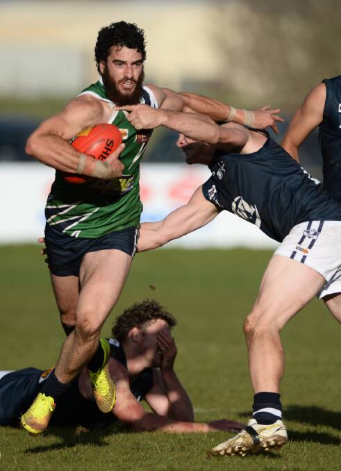 STRENGTH: Loddon Valley midfielder Adam Parry fends off Central Highland's Alan Ware on Saturday at Bungaree. Pictures: ADAM TRAFFORD