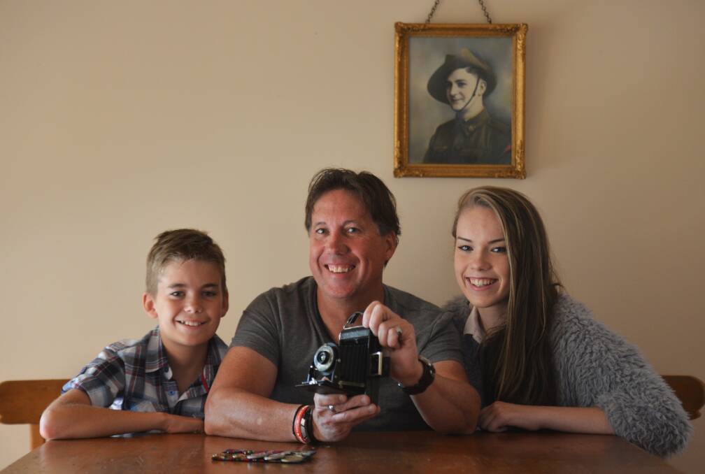 FAMILY HISTORY: Andrew Dixon shows off his father Herb Dixon's cherished Kodak Folding Brownie camera to children Karl and Brandy. Picture: BRENDAN McCARTHY