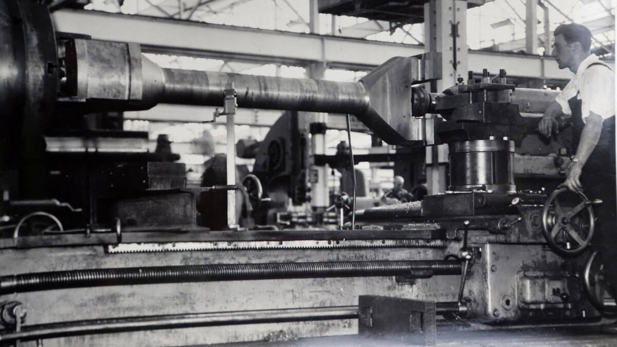 A Bendigo Ordnance Factory staff members works a giant lathe. Do you know the staff member?