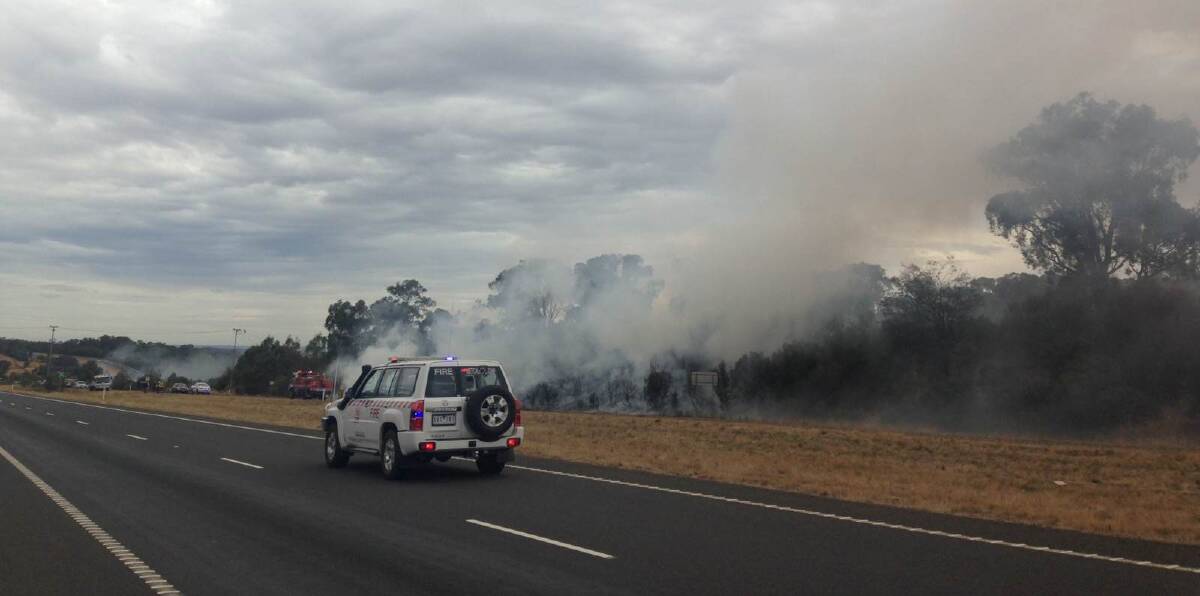Car engulfed in flames, sparks bushfire