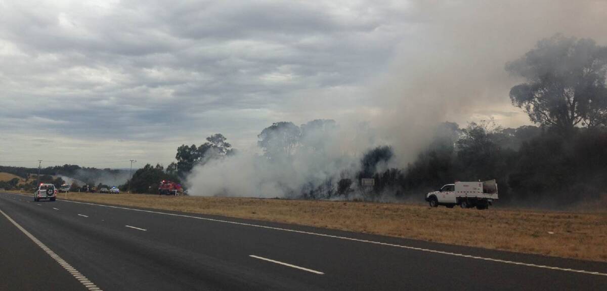 The car is engulfed in flames beside the Calder Freeway. Pictures: EMMA-JAYNE SCHENK
