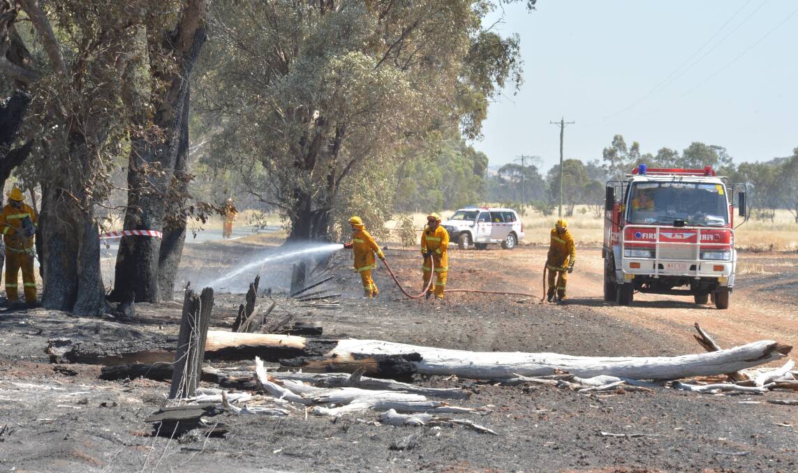 HOT SPOTS: CFA crews monitor the Toolleen fireground on Friday morning. Picture: PETER WEAVING