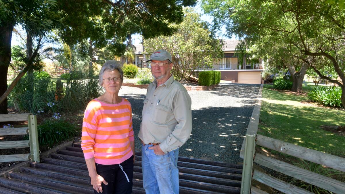 BURNT: Peter and Norma Hamilton survey the fire damage. Picture: PETER WEAVING