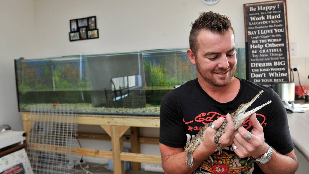 ALL SMILES: Warren the pet crocodile at home with his owner Nic Dyer. Picture: JODIE DONNELLAN