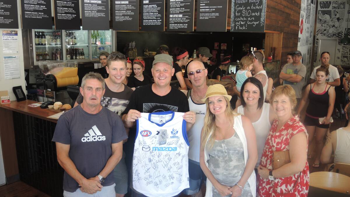 Grill'd owner Richard Nash holding his jumper, with Geoff Dudley to his right and other members of the Kristy Thomson appeal committee.