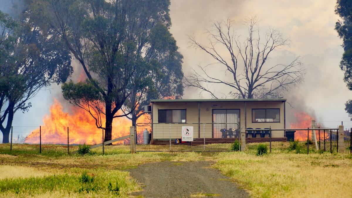 BEFORE: Fire draws near the vineyard office on Thursday. Picture: LUKE WALLIS