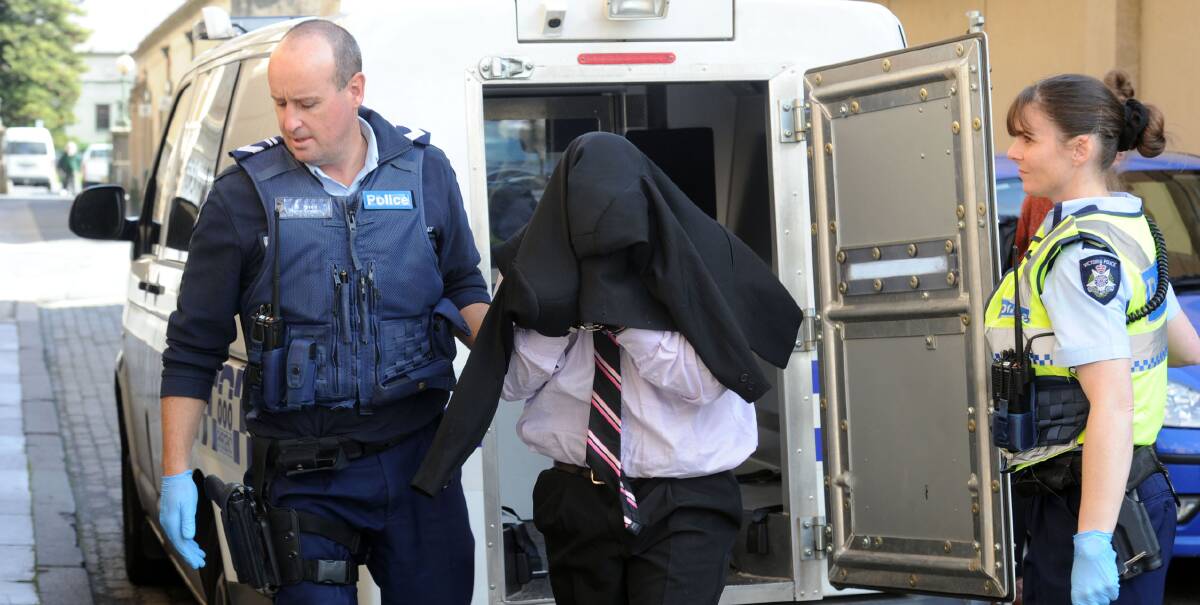 ACCUSED: Harley Hicks is escorted to court by police. Picture: BRENDAN McCARTHY