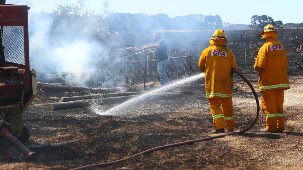 ALERT: Firefighter tackles fire at Malmsbury, near Kyneton, on Sunday. Picture: PETER WEAVING
