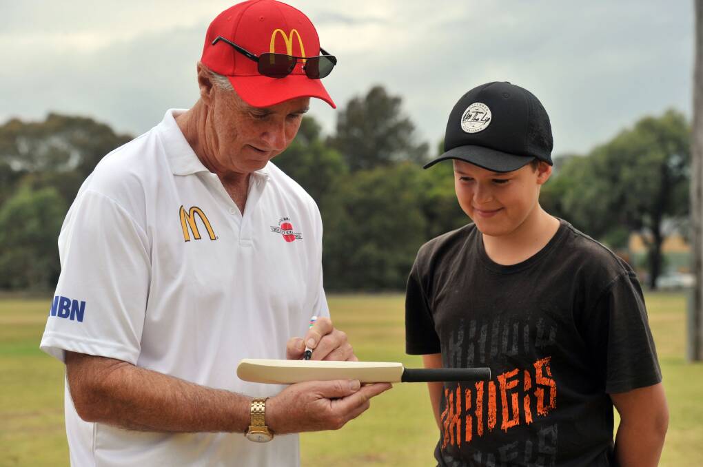 Cricket Camp at Ewing Park. Tyson Towers gets an autograph from Coach and Former Australian Test Captain Graham Yallop. Picture: BRENDAN McCARTHY