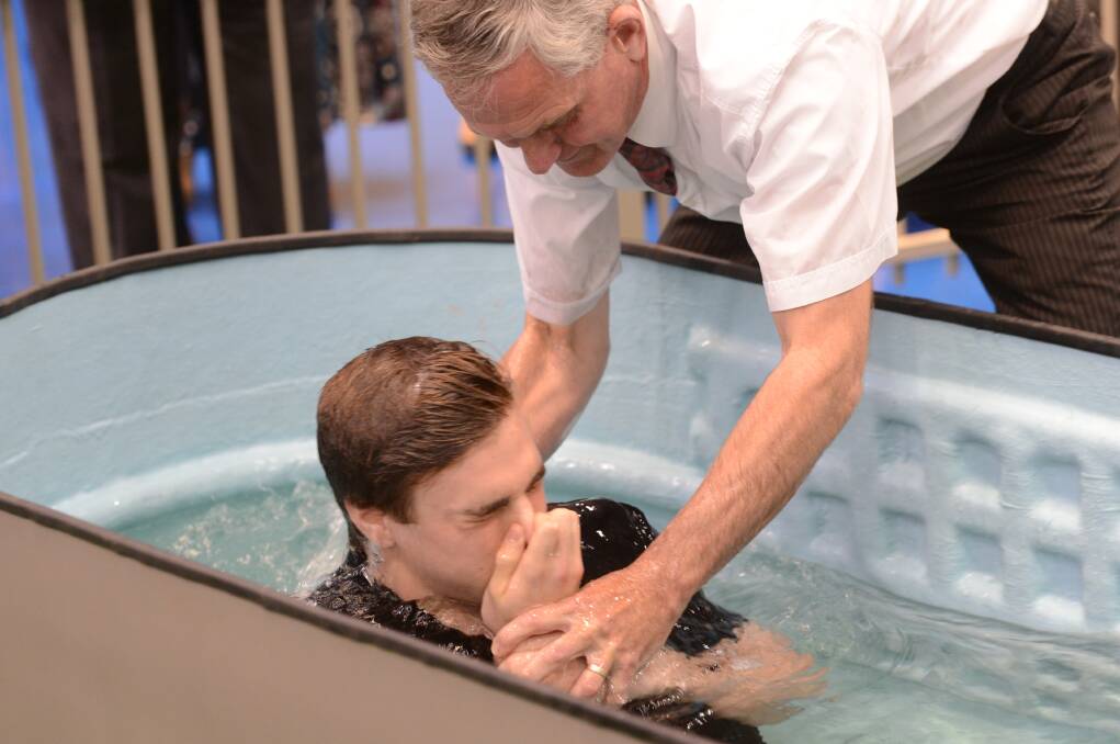 Micah Frahmien from Portland is baptised by Steve Marshall at the District Convention of Jehovah's Witnesses at the Bendigo Stadium. Picture: JIM ALDERSEY