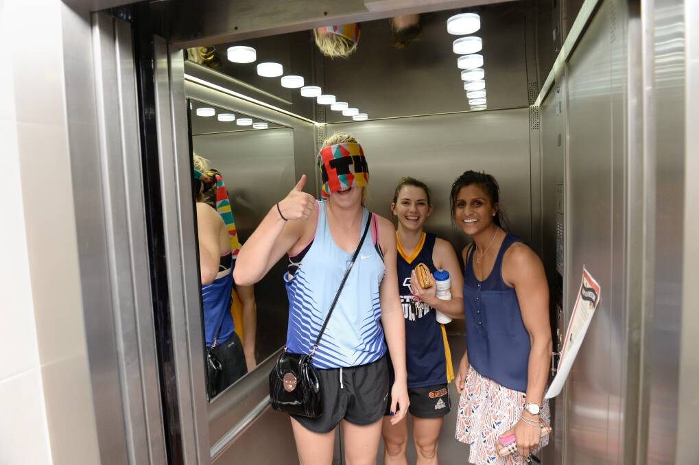 The three Spirit stars ride the elevator to the Addy office. Picture: JIM ALDERSEY