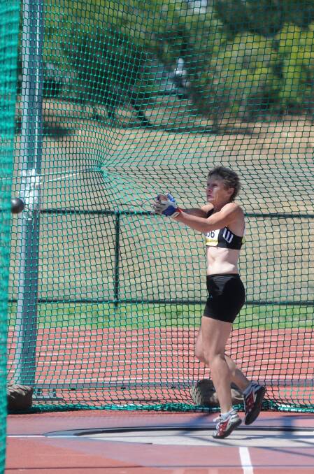 Claire Giles takes her turn in the hammer throw. Picture: JODIE DONNELLAN 
