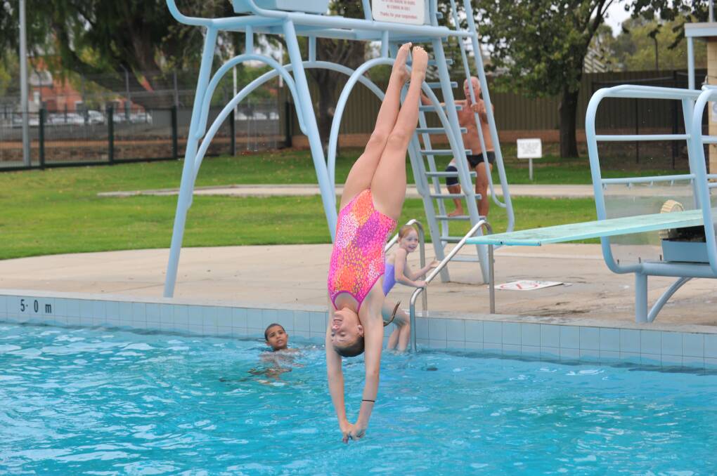 HEAD FIRST: Abby Rowley practiceses one of her dives at the Bendigo Aquatic Centre. Picture: JODIE DONNELLAN 