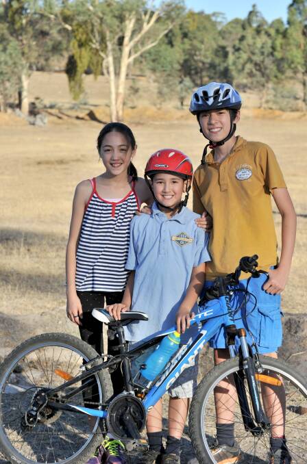 FAMILY FUN: Ava, 11, Hamish, 8 and Ollie Ueno, 14 are all a part of the cycling club. 