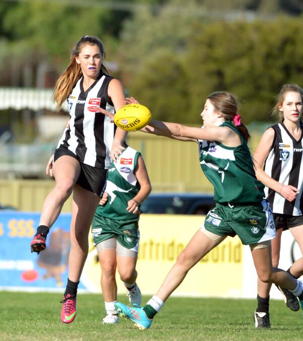 BACK IN ACTION: Meg Tong kicks the ball in round one footy between Castlemaine and Kangaroo Flat.