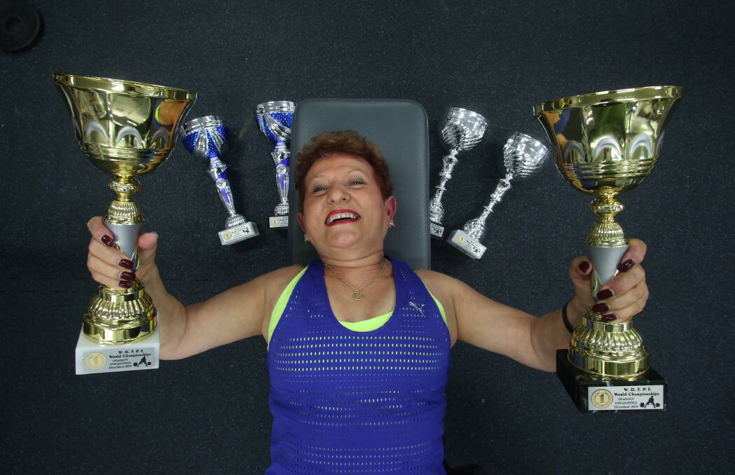 RECORD BREAKER: Weightlifter Helen Kostadinos with her six world titles in Bendigo. Picture: PETER WEAVING