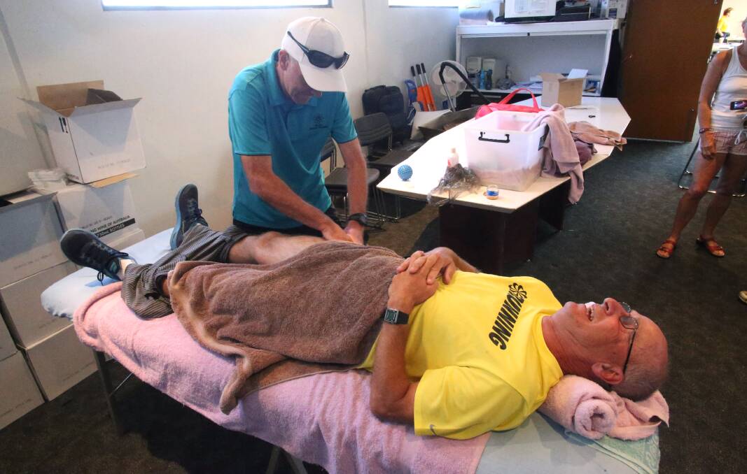Volunteer massager Kevin Shanahan works on Bill Carr from Dromana. Picture: PETER WEAVING