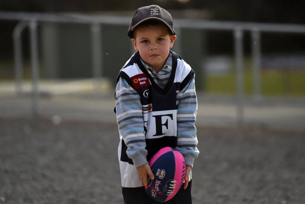 Four-year-old Nate Fitzpatrick shows off his footy. Picture: JODIE DONNELLAN 