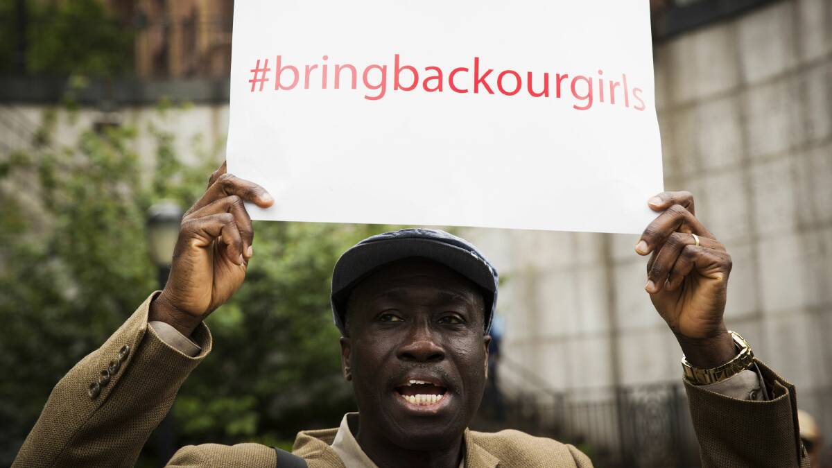A demonstrator holds a sign above his head while chanting for the release of the Nigerian schoolgirls in Chibok who were kidnapped by Islamist militant group Boko Haram, outside of the United Nations headquarters in New York, May 22, 2014.  Picture: REUTERS