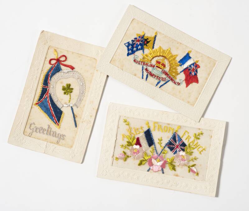 Unknown maker, Silk postcards  –  from brothers Harold, Richard and Walter Smith circa 1915-16, silk, card, coloured threads. Collection Bendigo District RSL Military Museum.