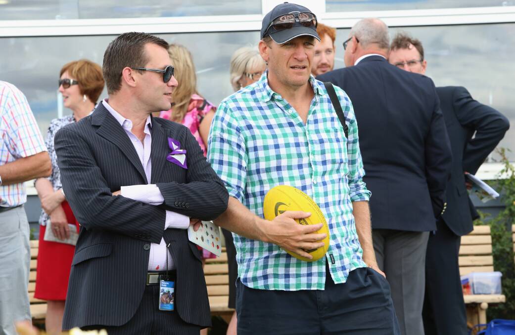 1990 Collingwood premiership player and media personality Michael Christian, right, enjoys Eloping's win. The horse is part-owned by his wife.
