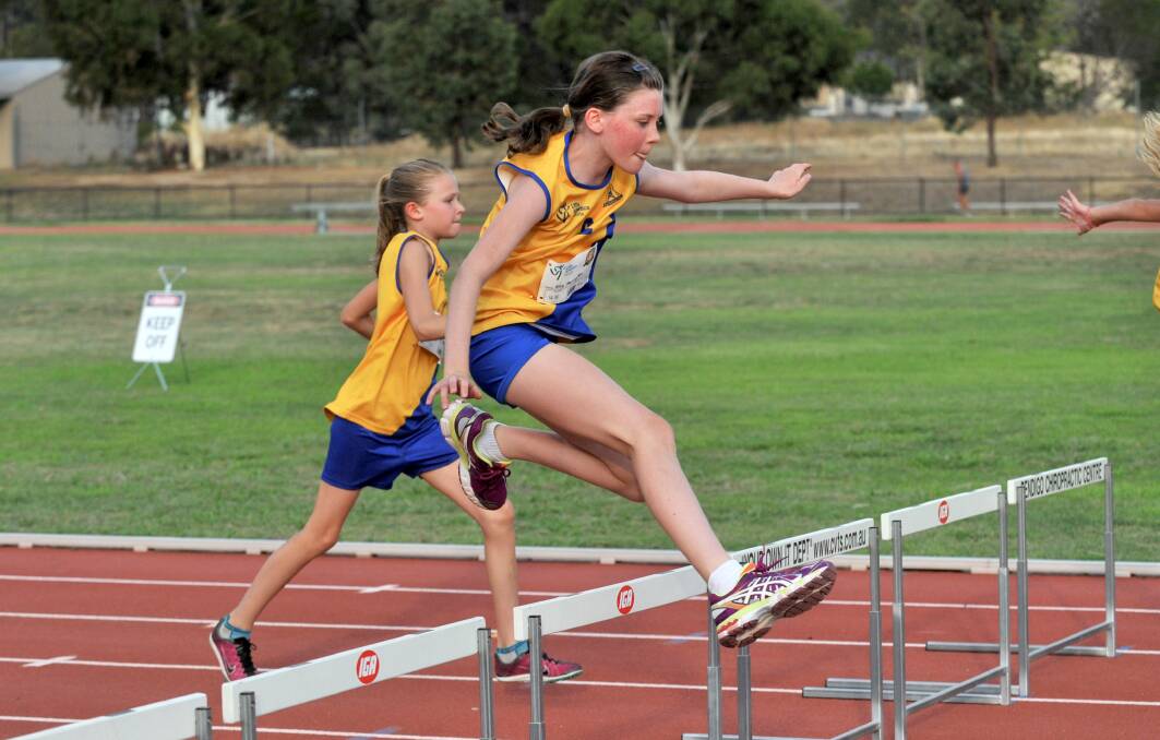 JUMP: Ella Harrington clears the hurdles at Bendigo Little Athletics.