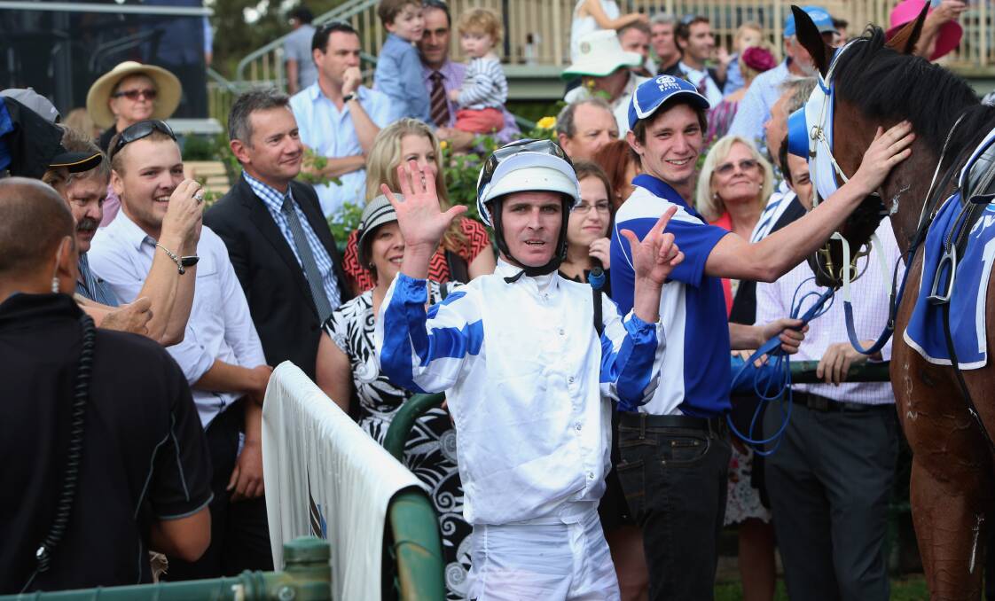 Luke Nolen puts up seven fingers to signify his 700th win with Peter Moody.