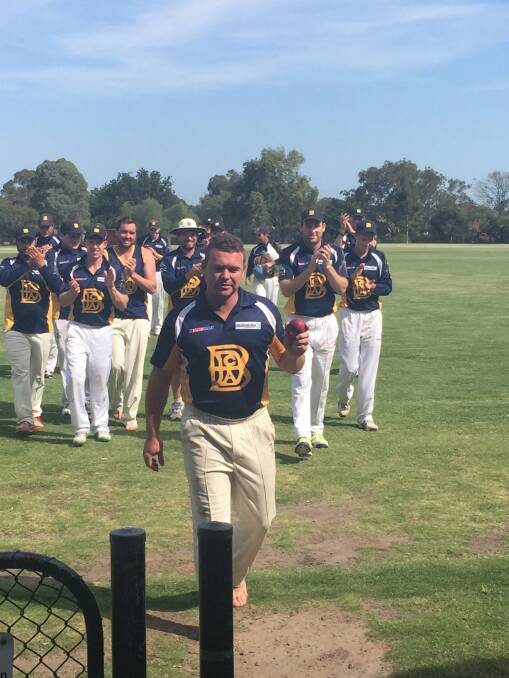 MILESTONE MAN: Adam Burns leads Bendigo off the field after taking his 100th career wicket at Melbourne Country Week. Picture: SHANE HARLING