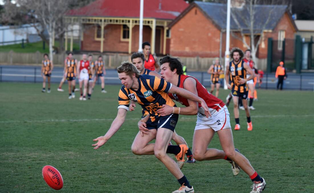 IN FRONT: Gold's Matt Farrelly leads the race for the ball.