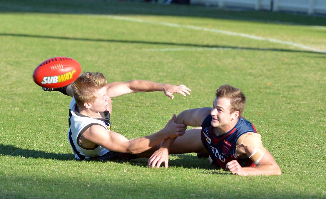 HARD AT IT: Maryborough's Coby Perry and Sandhurst's Mitch Dole battle for possession of the ball. Picture: LIZ FLEMING