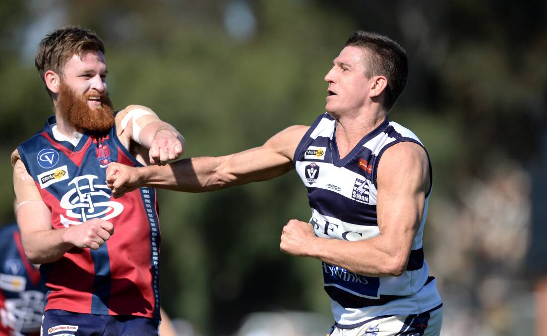 Steven Baker gets up close and personal with Sandhurst's Nick Stagg in the BFNL grand final. Picture: JIM ALDERSEY