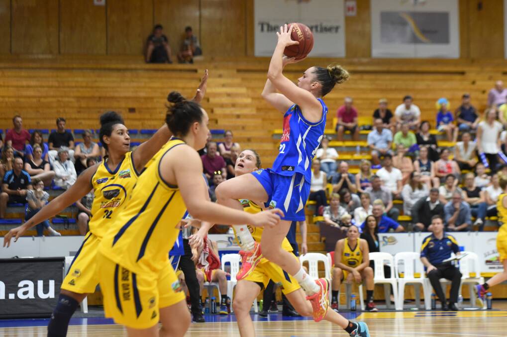 ALL CLASS: Kelly Wilson climbs high to shoot in her match-winning performance for the Bendigo Spirit in Sunday's preliminary final. Picture: JIM ALDERSEY