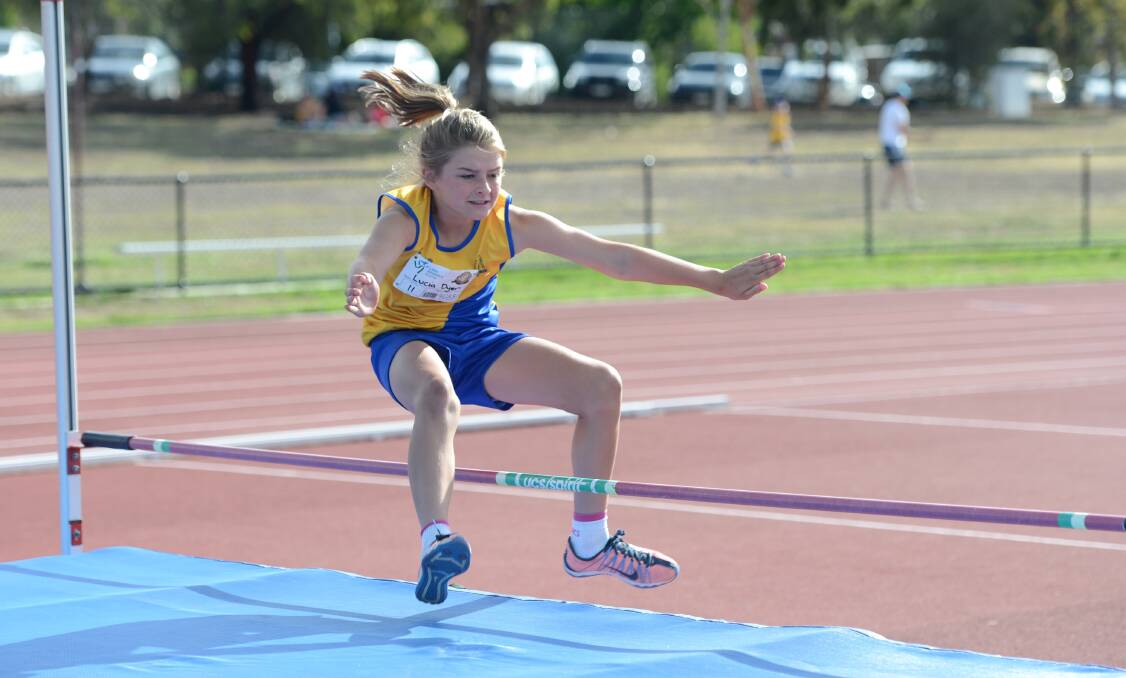 Lucia Dyer in the under-11 high jump.
