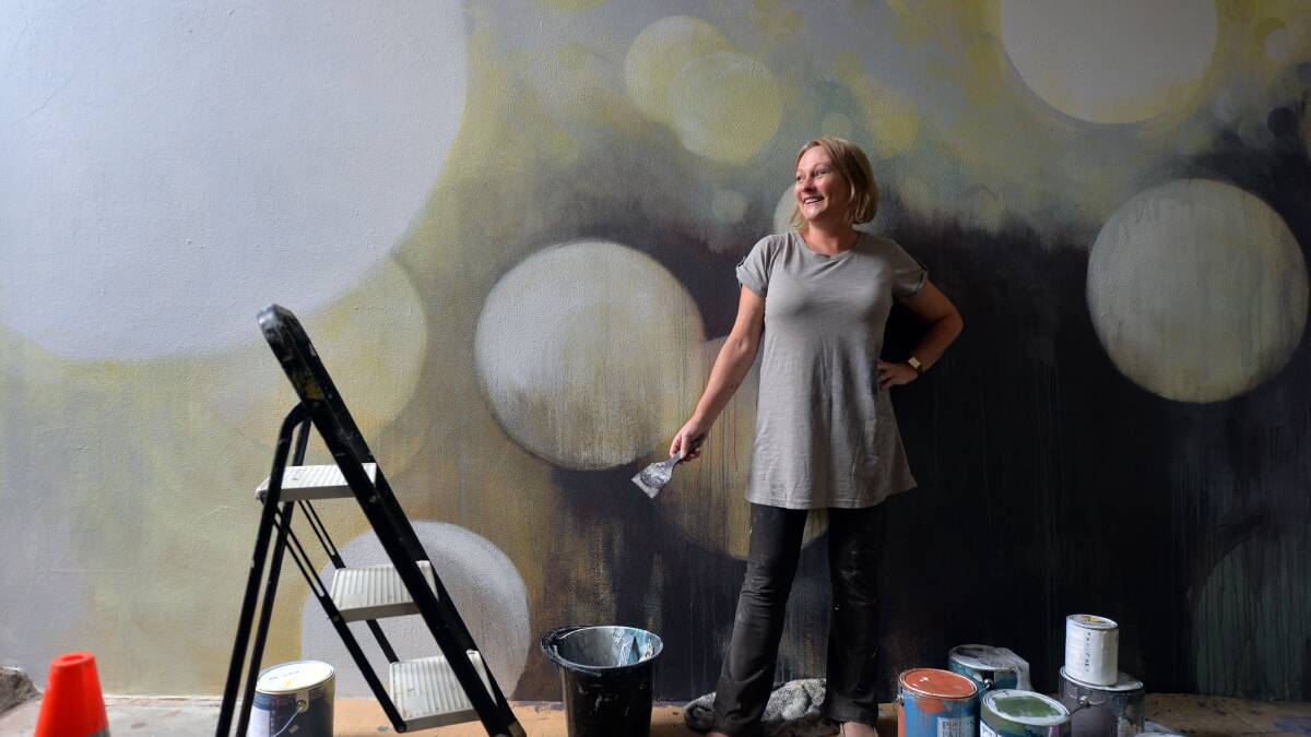 INSPIRED: Artist Julie Andrews working on the mural in Chancery Lane
Picture: BRENDAN McCARTHY
