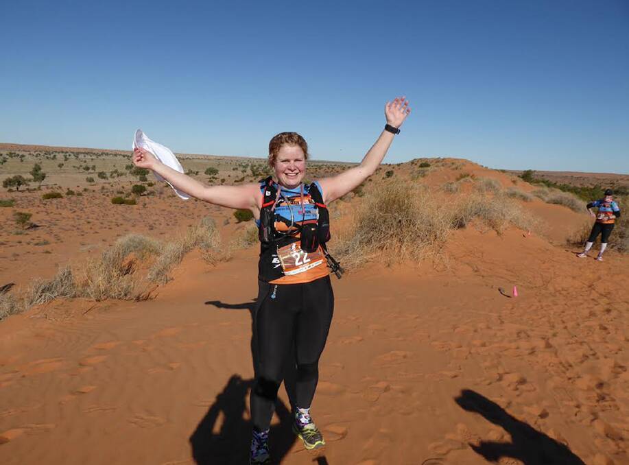 REJOICE: Izzi celebrates after conquering 400 sand dunes in six days. Pictures: CONTRIBUTED
