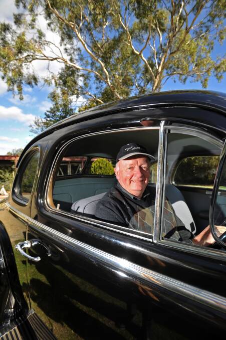 VINTAGE: Geoff Pollard sits proudly in his completely refurbished 1937 black Cadillac LaSalle.