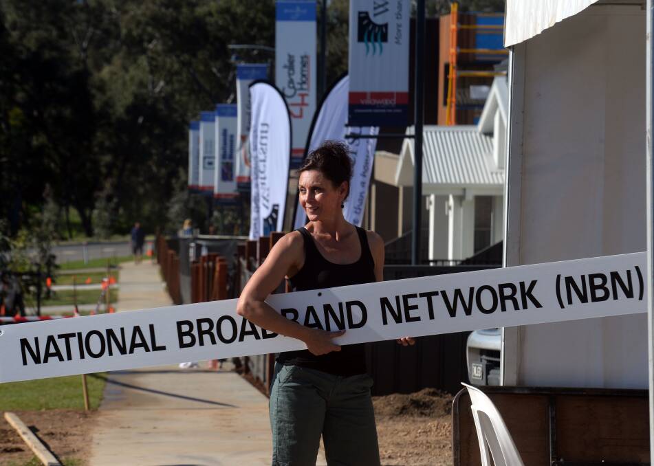 OPEN: Villawood's Jennifer Turner helps set up a stall at the village open day.