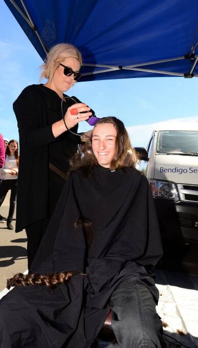 HAPPY: Rebecca Vemer has her head shaved by Rachael Kirby.