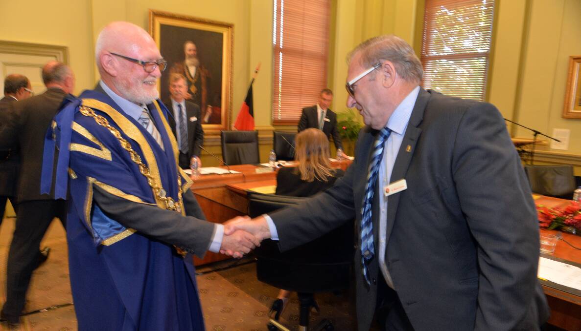 CONGRATULATIONS: Former mayor Barry Lyons congratulations Peter Cox. Picture: BRENDAN McCARTHY