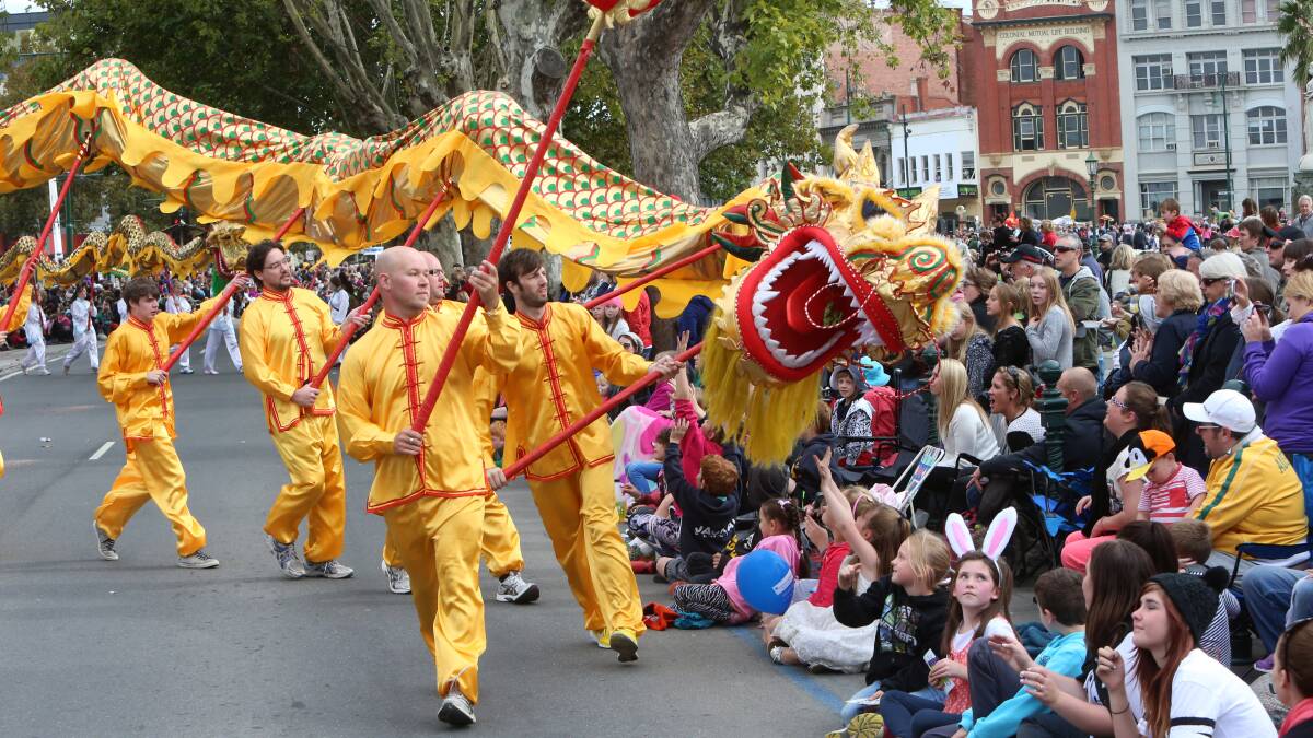 IN AWE: The crowd admire one of the dragons in yesterday's Easter parade. Picture: PETER WEAVING