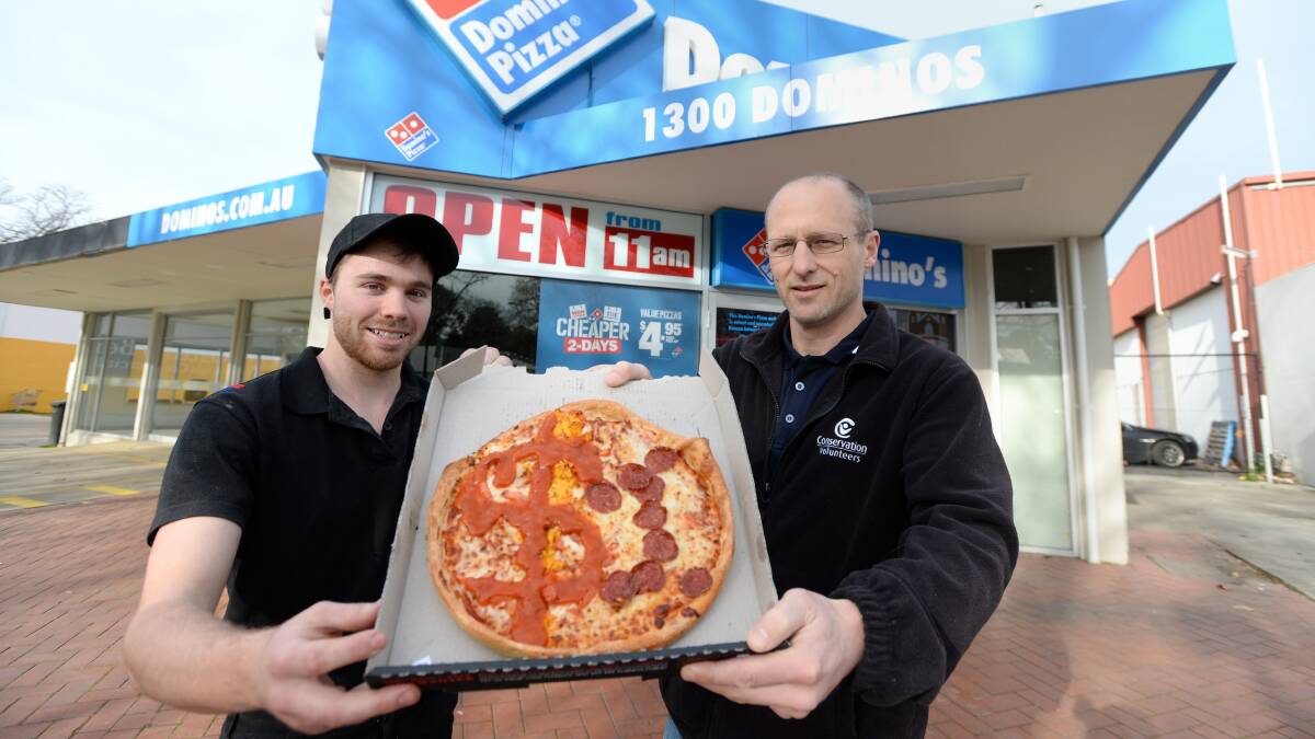 CONSERVATION: Domino's Pizza Bendigo manager Jake Robertson with Adam Smolak. Picture: JIM ALDERSEY