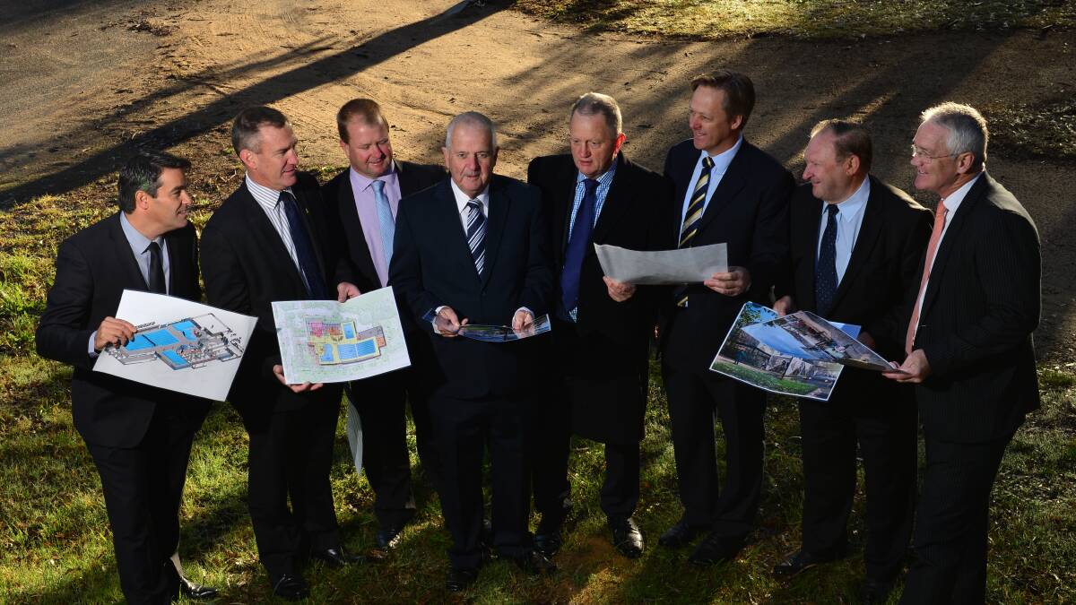 FUNDING: Barry Lyons, Damian Drum, council members and Liberal Party candidates look at the plans for the centre. Picture: JIM ALDERSEY