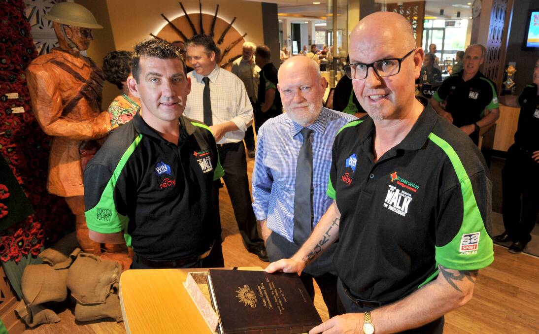 HONOUR: Scott Hosking, Cr Peter Cox and Brendan Baker and the launch of a commemorative book acknowledging Australian soldiers.