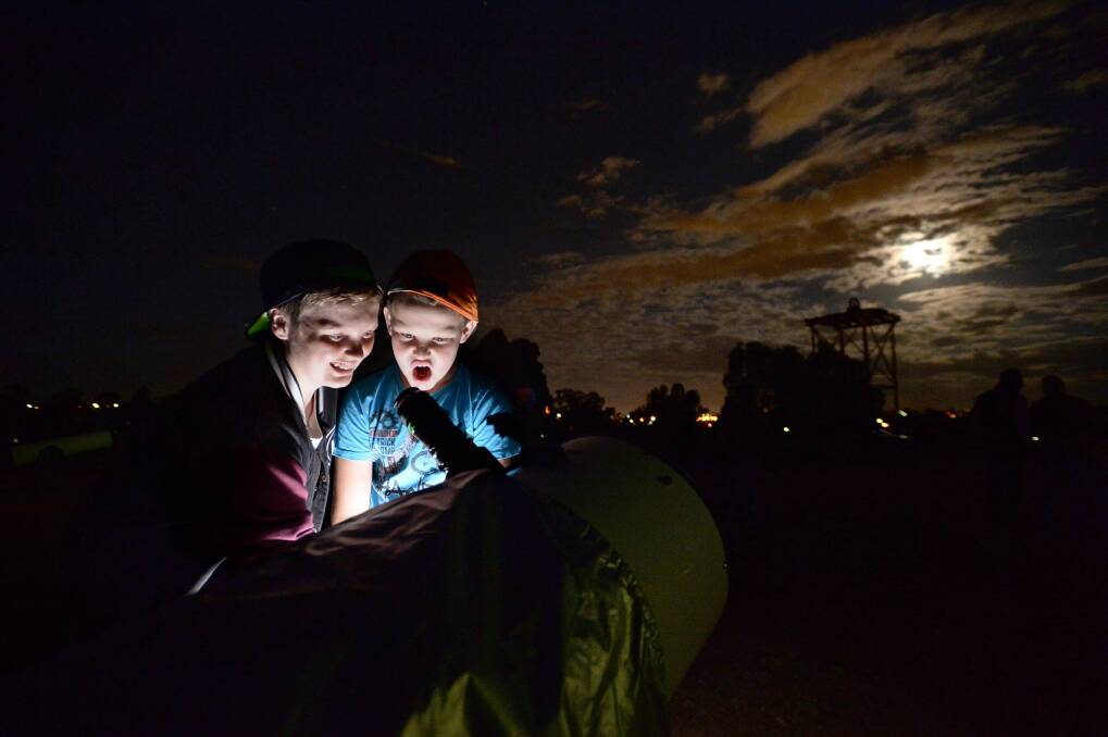 FASCINATING: Keoni MacRae and Jackson Dole have a look at the eclipse. Picture: JIM ALDERSEY