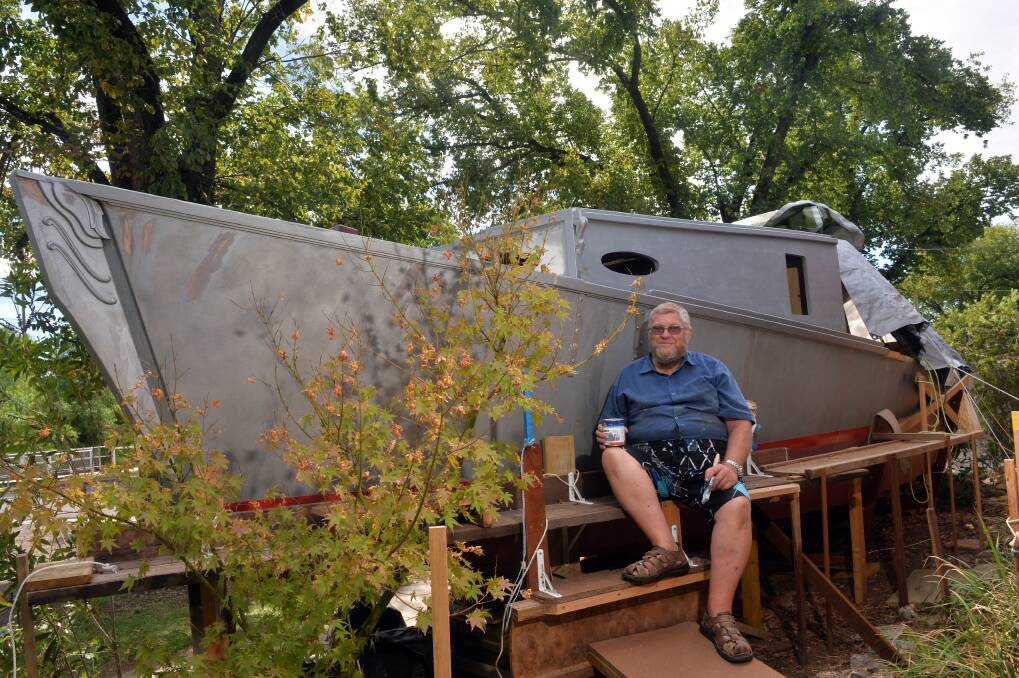 PROJECT: Hugh Murdoch and his boat. Picture: BRENDAN McCarthy