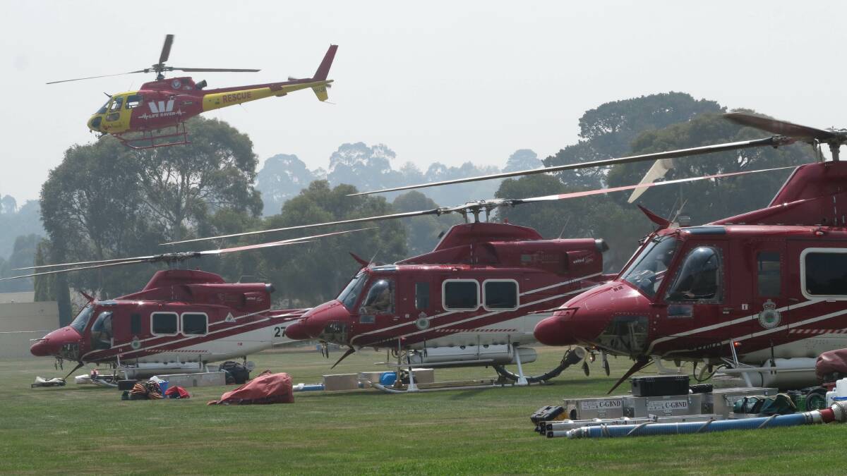 PATROL: Five fire helicopters taking off from Gisbone yesterday. Picture: PETER WEAVING