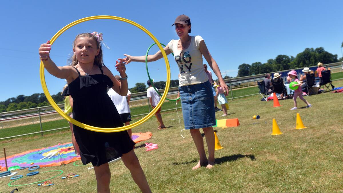 Mia and mum, Michelle Turner,  try the hula hoops.